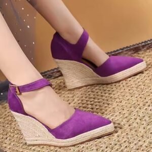 woman wearing purple wedges on a beige carpet