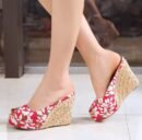 woman wearing women's colorful wedges on the white tiles