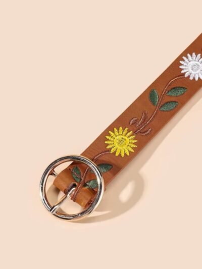 silver buckle and material of Western colorful belt on the beige background