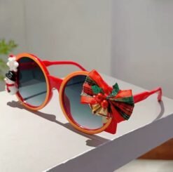 side view of colorful Christmas sunglasses on a white table