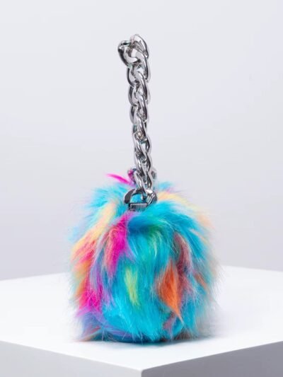 side view of colorful bag with a chain on the white table