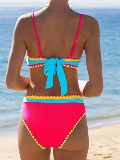 woman turned to her back wearing colorful bikini set on the beach
