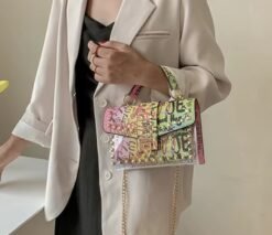 woman wearing colorful graffiti bag, beige blazer and a black top