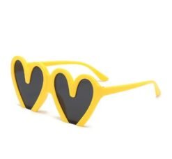 yellow variation of colorful heart shaped sunglasses on the white background
