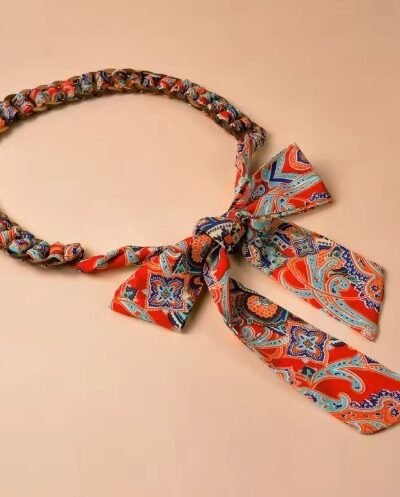 colorful knotted belt tied in a ribbon on the beige background