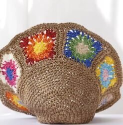 colorful straw hat lying on a white surface