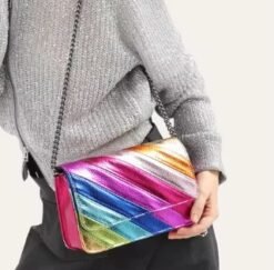 woman wearing colorful striped bag and a grey sweater