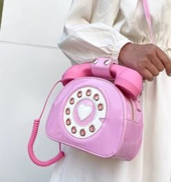 woman wearing a white dress and pink colorful telephone bag