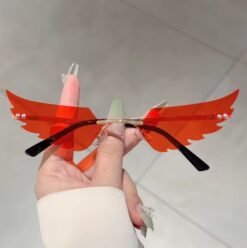 woman holding orange variation of colorful wings shaped sunglasses