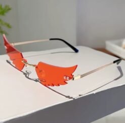 orange variation of colorful wings shaped sunglasses on a white table