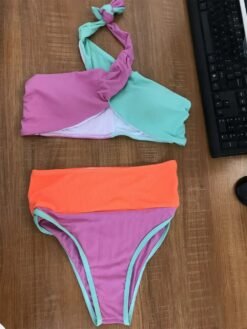 front view of criss-cross colorful bikini on the wooden table