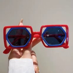 woman holding designer colorful sunglasses