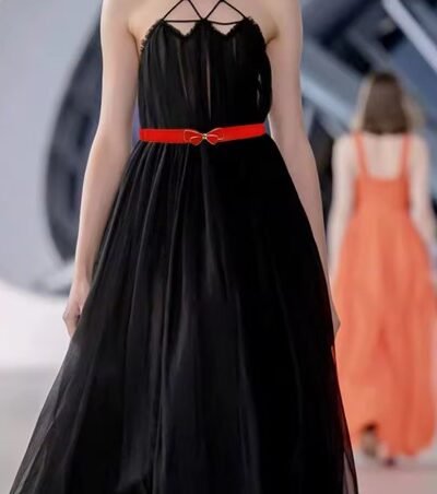 woman wearing red elegant belt on the black dress