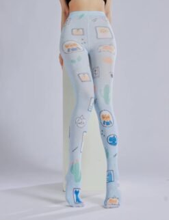 woman wearing fun tights and siting on a white elevation