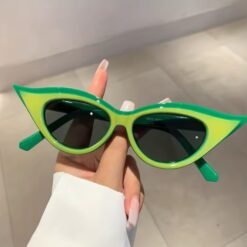 woman holding green cat eye sunglasses