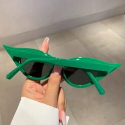 back view of green cat eye sunglasses in a hand