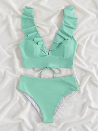 front view of mint bikini on a white bedsheet