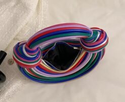 opened retro colorful bag on the white bed