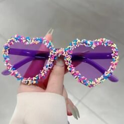woman holding purple variation of sunglasses with colored frames