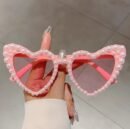 woman holding sunglasses with pearls