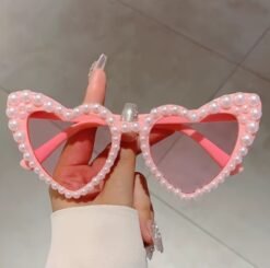 woman holding sunglasses with pearls