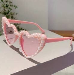 side view of sunglasses with pearls on a white surface