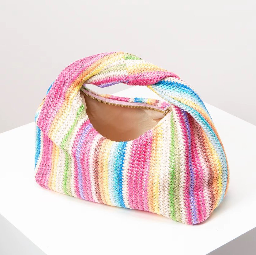 opened vintage colorful bag standing on the white table