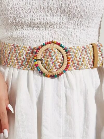 woman wearing wide colorful belt and a white dress
