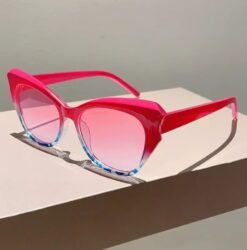 side view of women's colorful sunglasses on a beige table