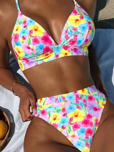 woman wearing bright colored bikini and sitting on a white blanket