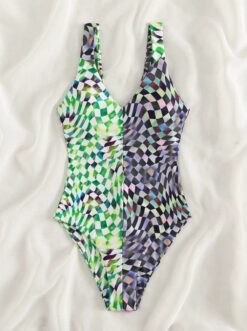 front view of colorful checked one piece swimsuit lying on a white blanket