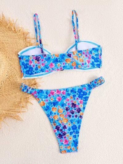 back view of colorful high cut bikini on a white surface, a beige sunhat next to it