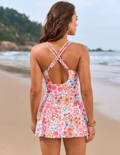 woman turned to her back wearing colorful one piece swimsuit with a skirt