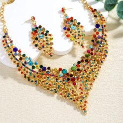 colorful rhinestone jewelry set lying on a white and beige surface