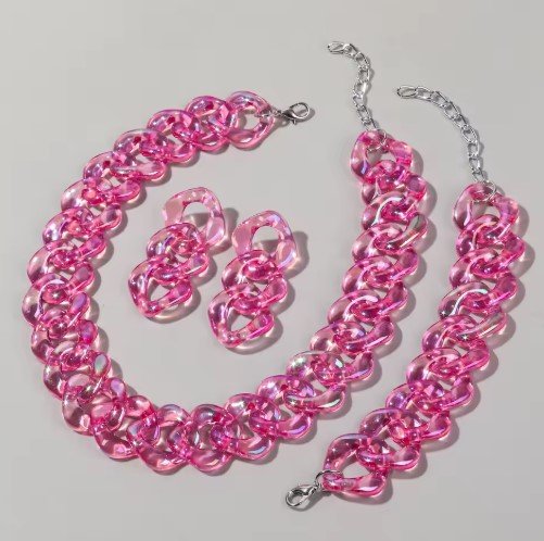 pink variation of statement jewelry set on the grey background