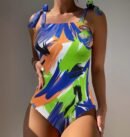 woman wearing vibrant colorful one piece swimsuit