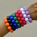 woman wearing colorful big beads bracelets