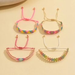 side view of colorful bracelets set on the beige background