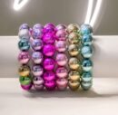 colorful metallic bracelets on a white wrist mannequin