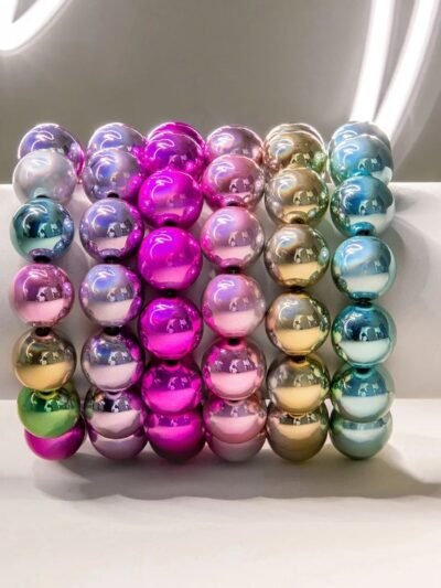 colorful metallic bracelets on a white wrist mannequin