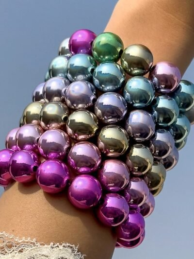 woman wearing colorful metallic bracelets