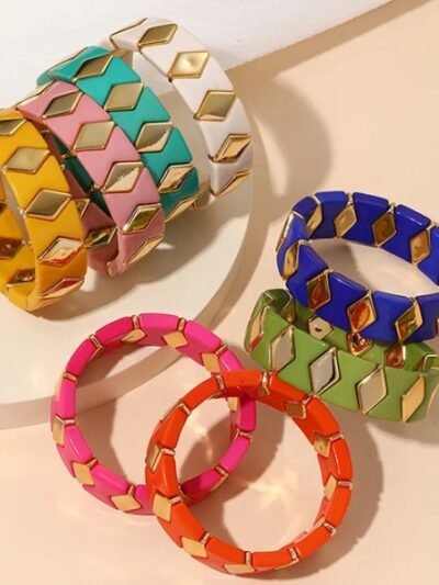 front and side view of colorful resin bracelets on the white nad beige surface