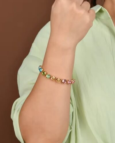 woman wearing shiny colorful bracelet and a green shirt