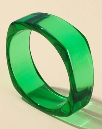 green transparent bracelet on the beige background