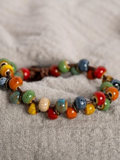 vintage colorful bracelet lying on a grey bedsheet
