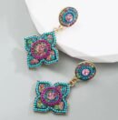 Bohemian colorful earrings placed on grey and white surface