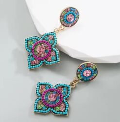 Bohemian colorful earrings placed on grey and white surface