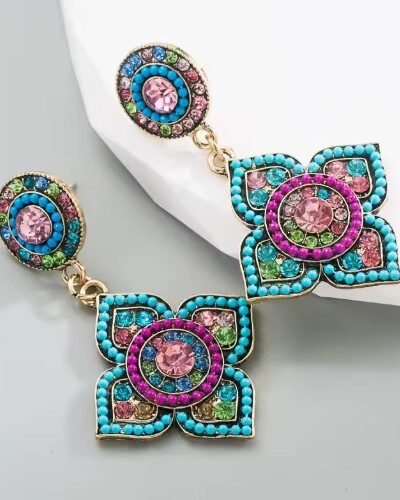 side view of Bohemian colorful earrings on a grey surface