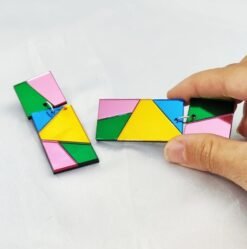 woman holding color block earrings