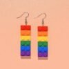 colorful building block earrings on the orange backgorund